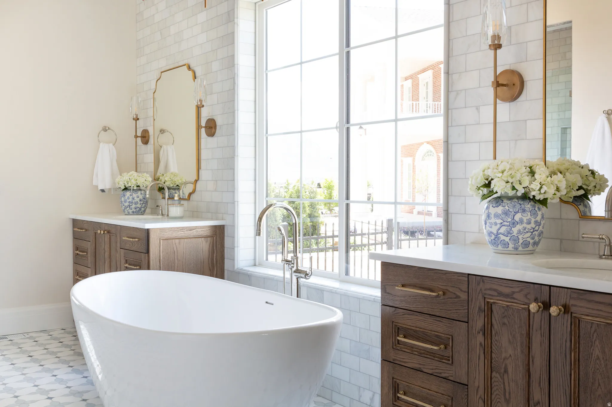 Freestanding soaking tub with a floor-mounted faucet