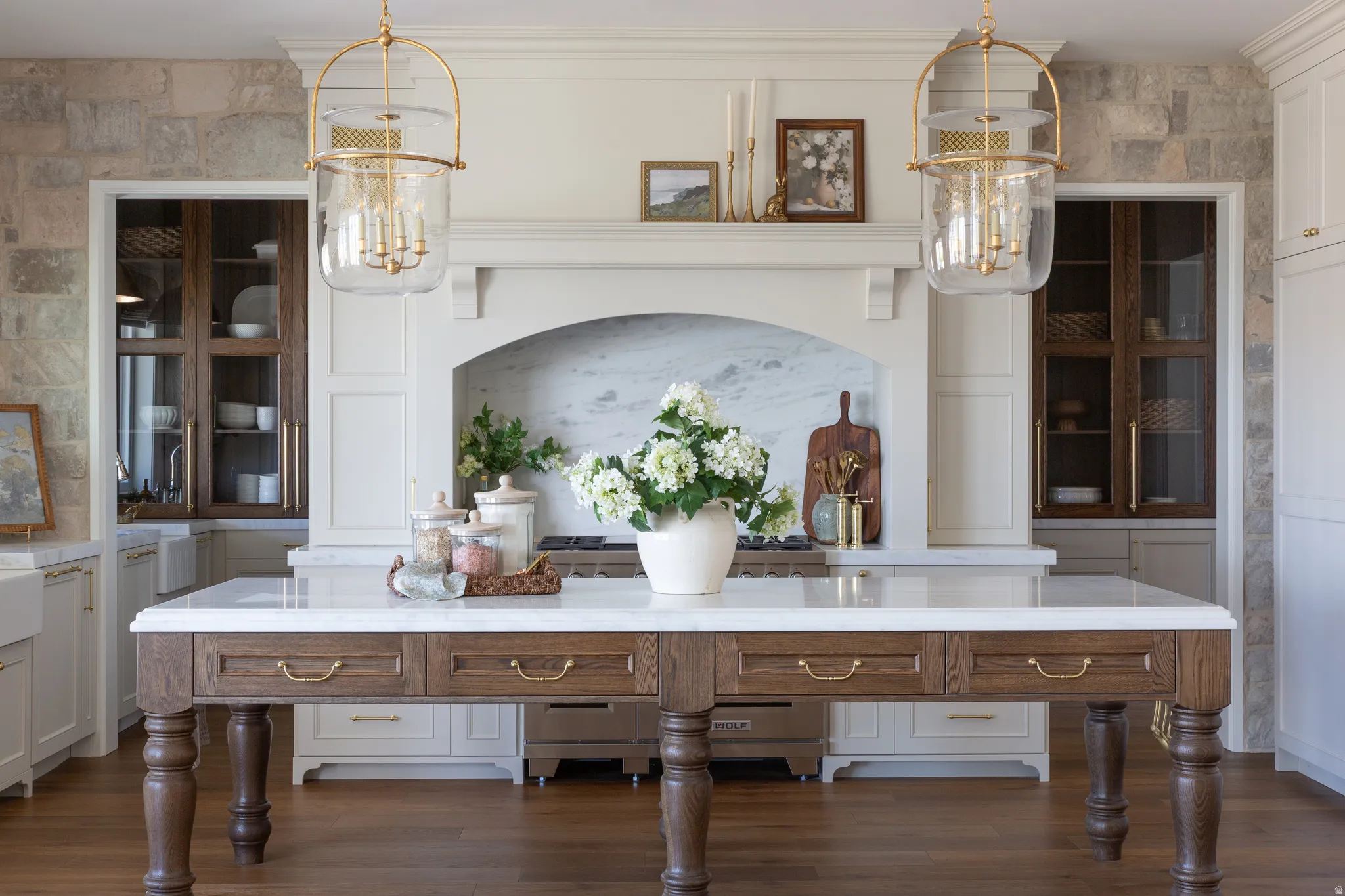 Central island with a light-toned countertop and wood-finish base