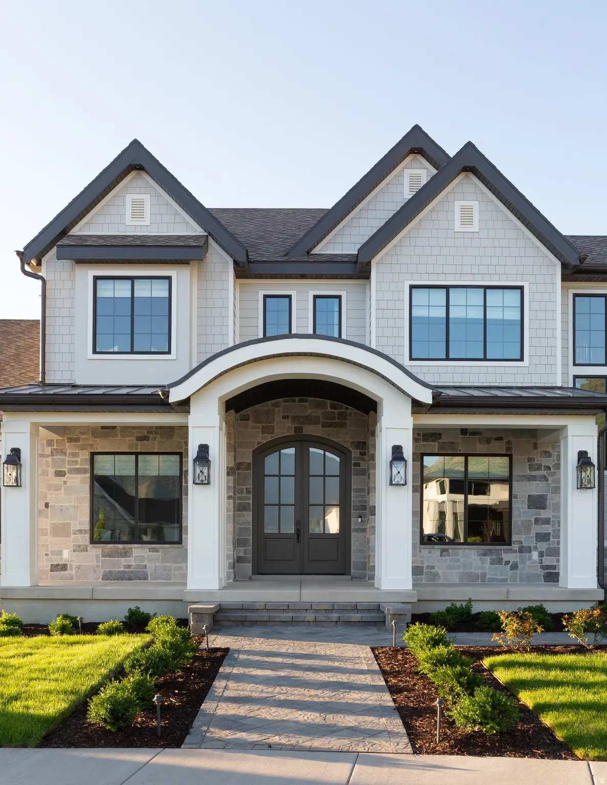 Stone and shingle exterior with dark trim accents