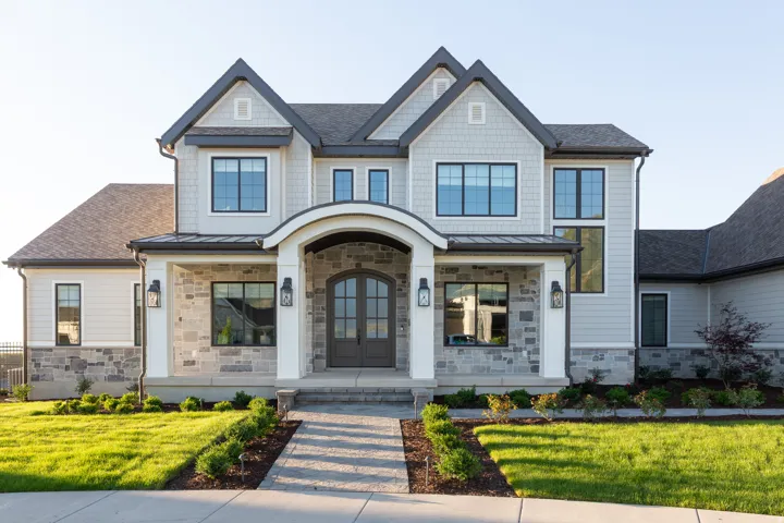 Stone and siding exterior with dark-trimmed windows