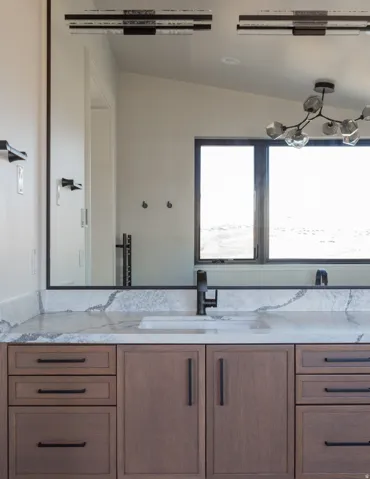 Built-in vanity with wood cabinetry and black hardware