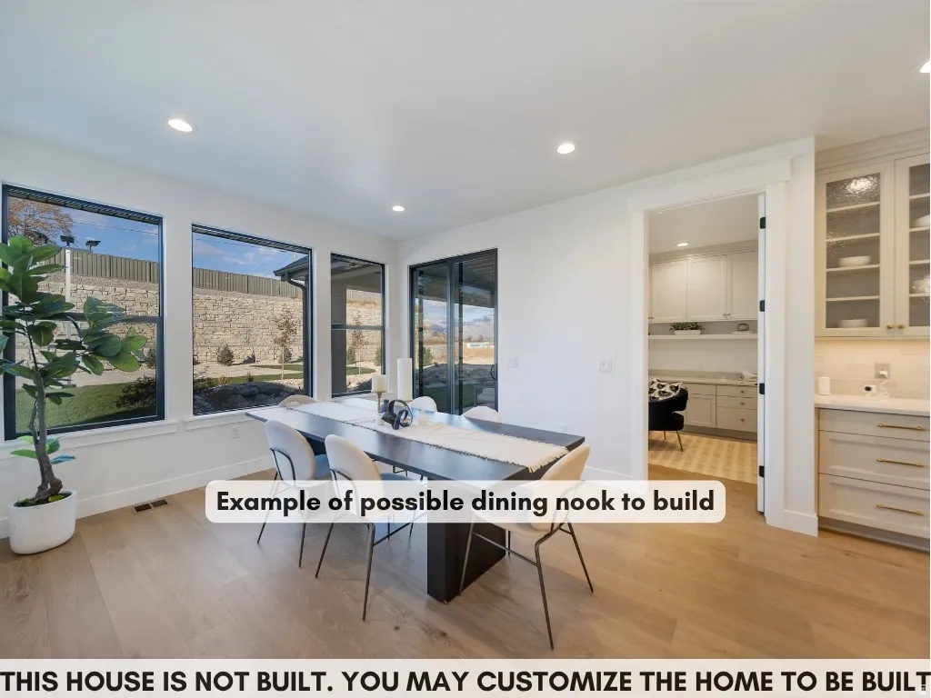 Wood-finish flooring, recessed lighting, and large windows with dark trim
