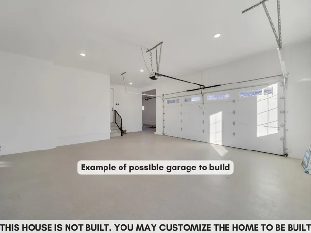Spacious garage with an overhead door featuring transom windows and an automatic opener