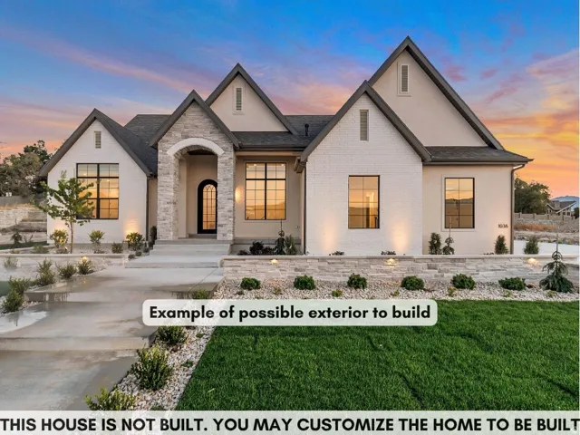 Gabled roofline, stone and stucco exterior, arched entry, black-framed windows, and manicured landscaping