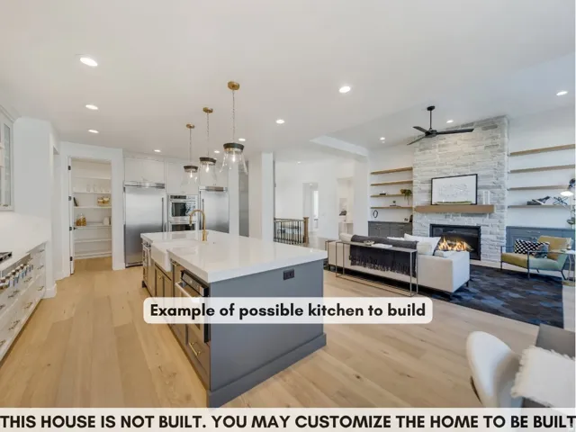 Wood-finish flooring throughout, kitchen island with built-in sink, stainless steel appliances, stone-clad fireplace with wood mantel, and integrated shelving