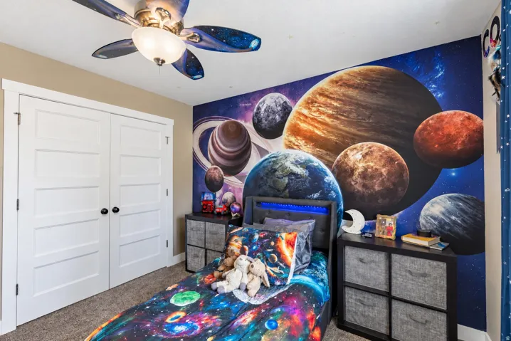 Built-in closet with four-panel doors, ceiling fan with integrated lighting, and wall-to-wall carpeting