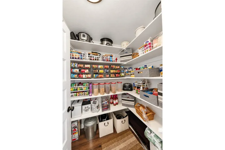 Built-in pantry shelving provides ample storage and organization