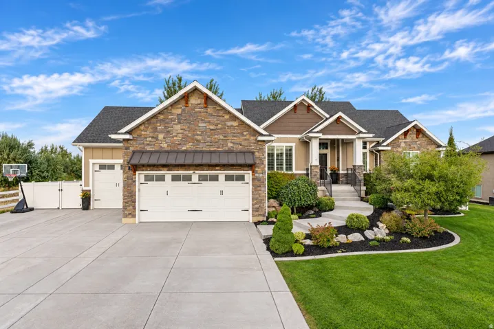 Stone and siding exterior with a dark shingle roof