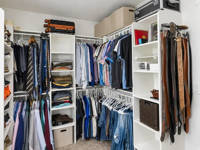 Custom closet system featuring multiple shelves, hanging rods, and built-in organizers