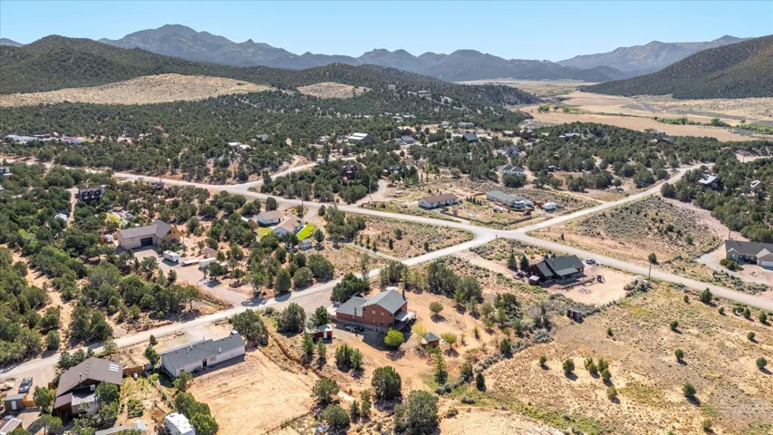 Expansive mountain landscape with scattered residential properties and established roadways
