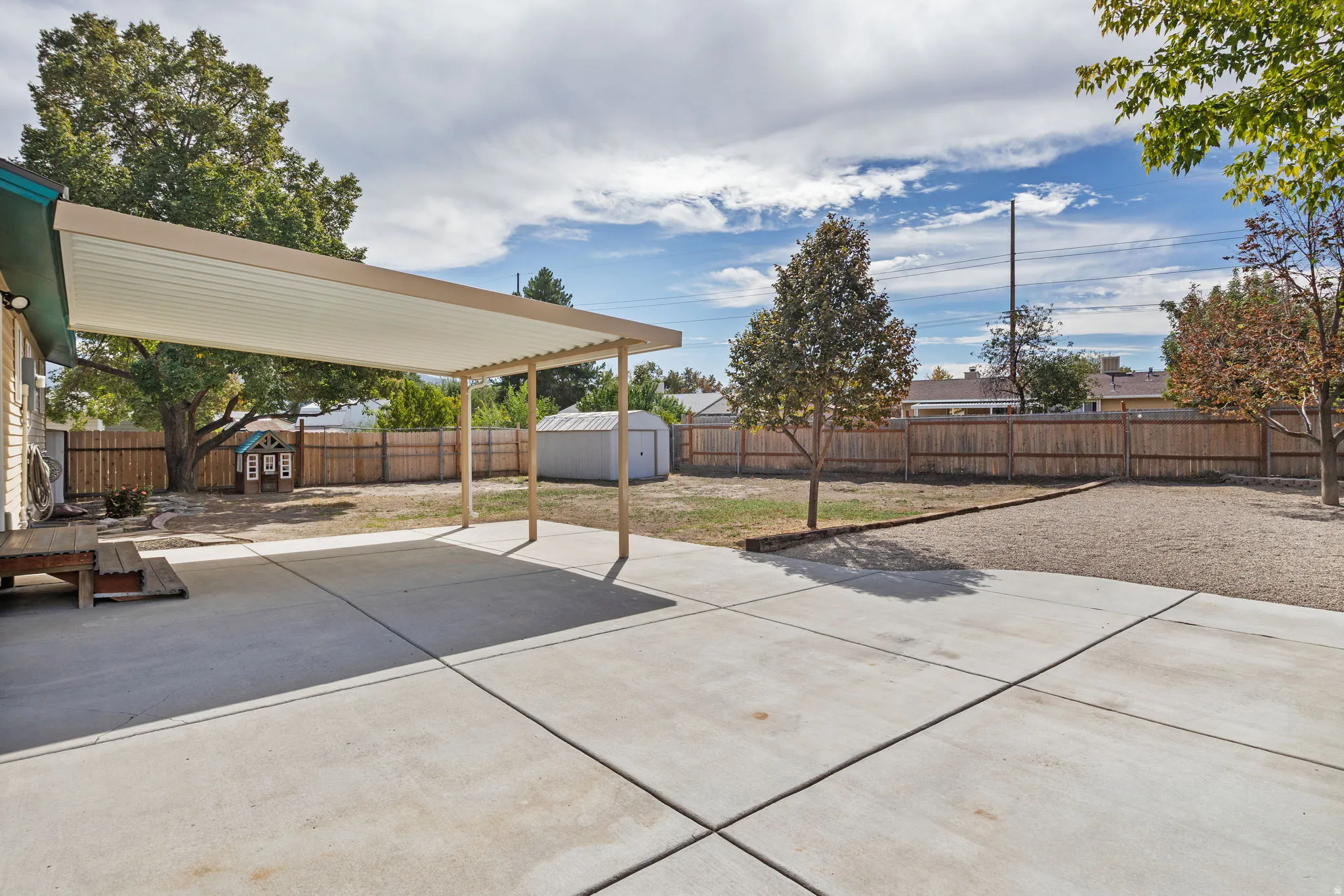 Expansive concrete patio with a covered pergola