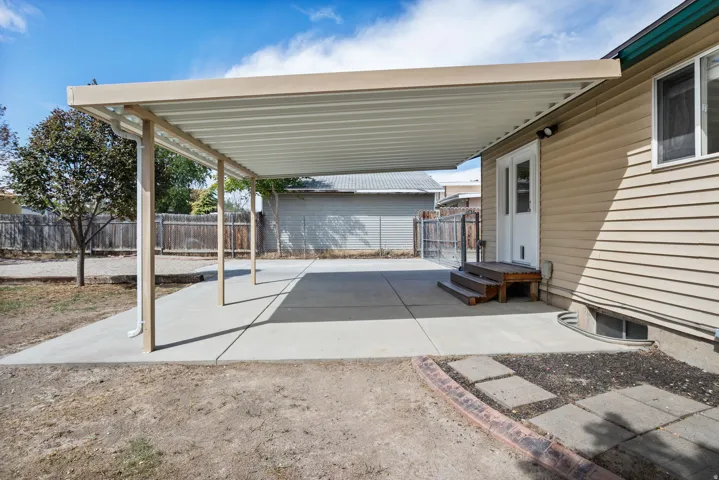 Expansive concrete patio with a full-length covered awning