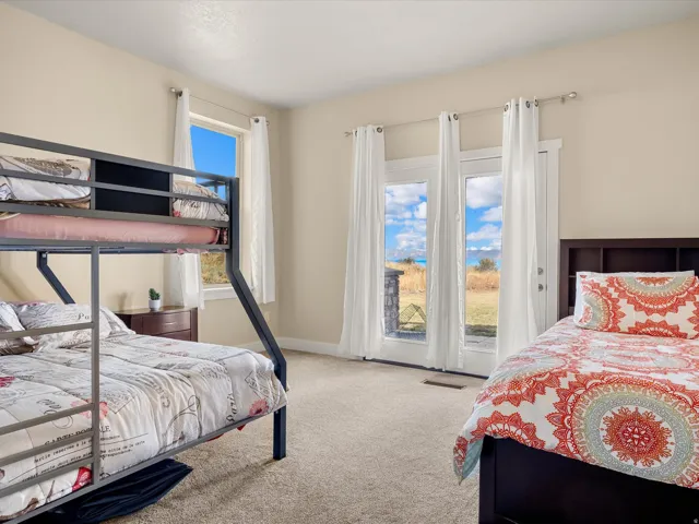 Carpeted room with light-colored walls and a window