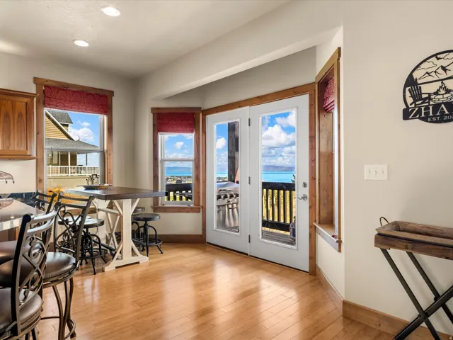 Hardwood flooring throughout, recessed lighting, and french doors with exterior access