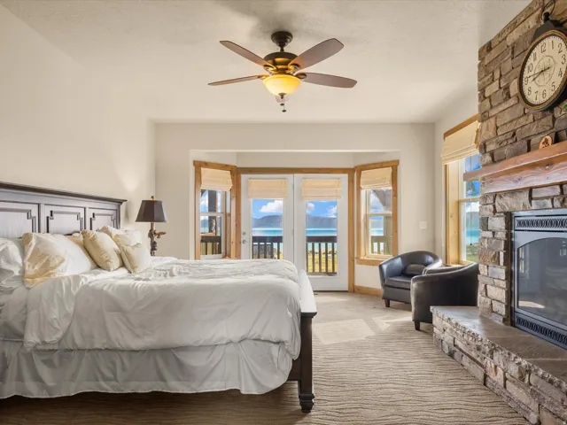 Stone-faced fireplace with hearth, wood mantel, and gas insert. Water view