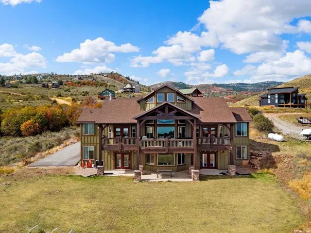 Multi-story residence featuring extensive wood siding and an expansive deck