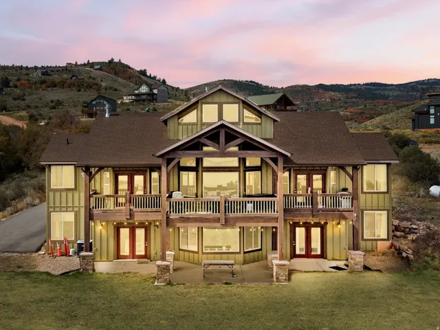 Multi-level dwelling with a gabled roof and board and batten siding