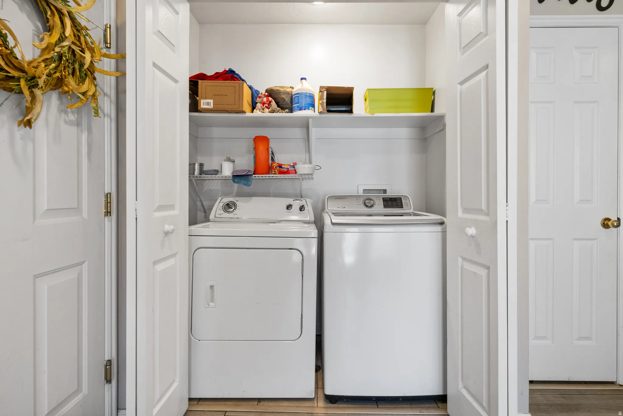 Built-in utility closet with bifold doors and shelving