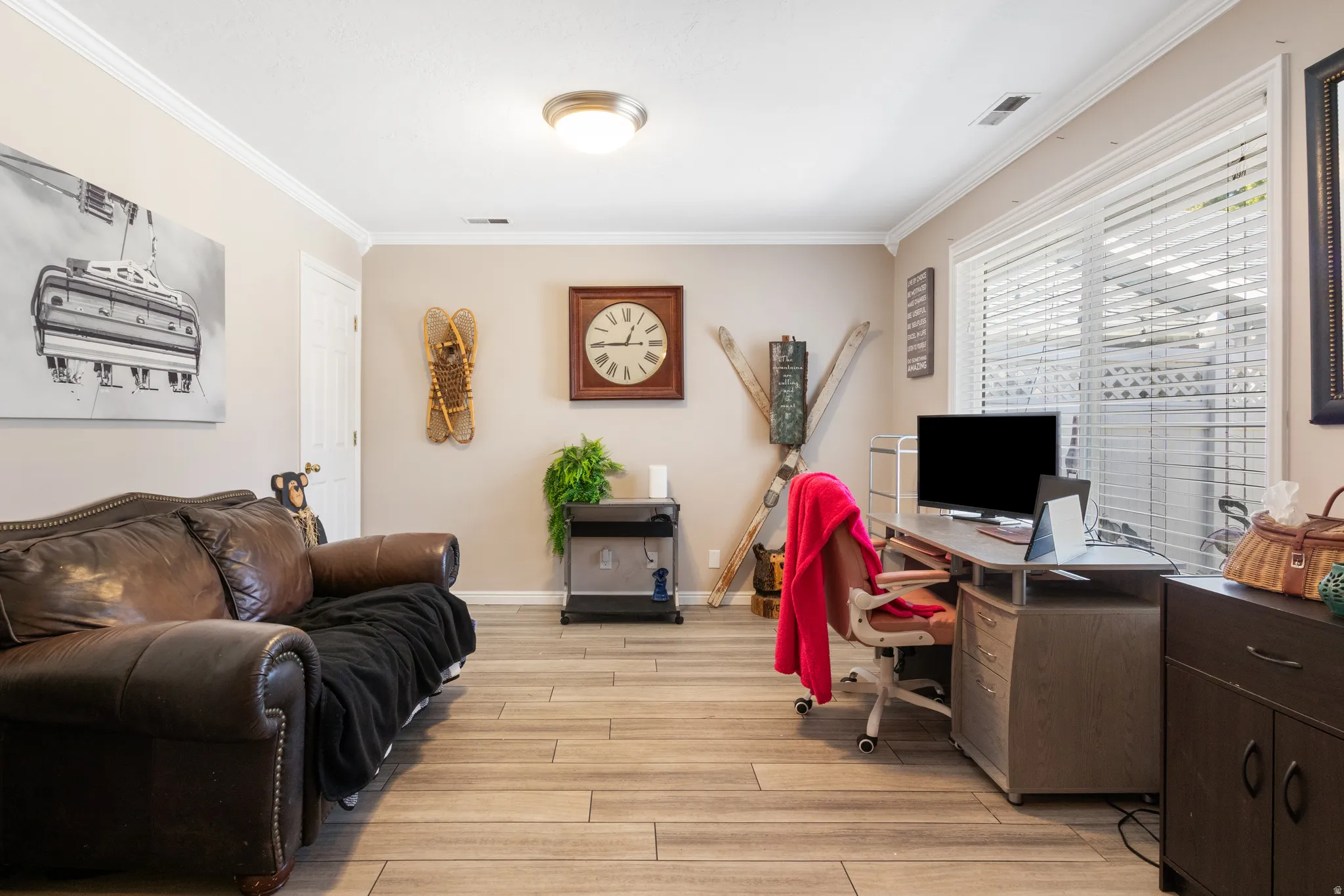 Recessed lighting, crown molding, wood-finish flooring, and a large window with blinds