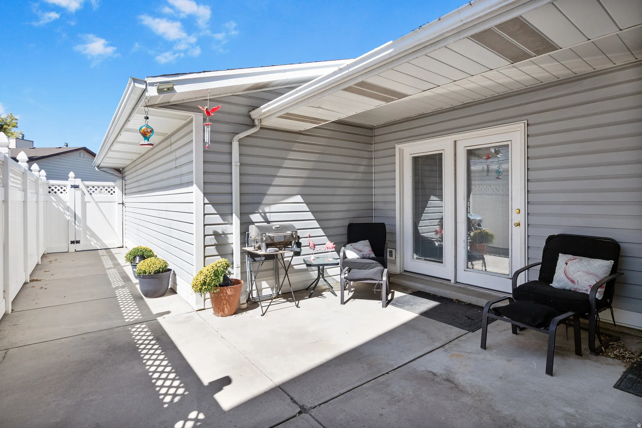 Concrete patio with dual pane glass French doors