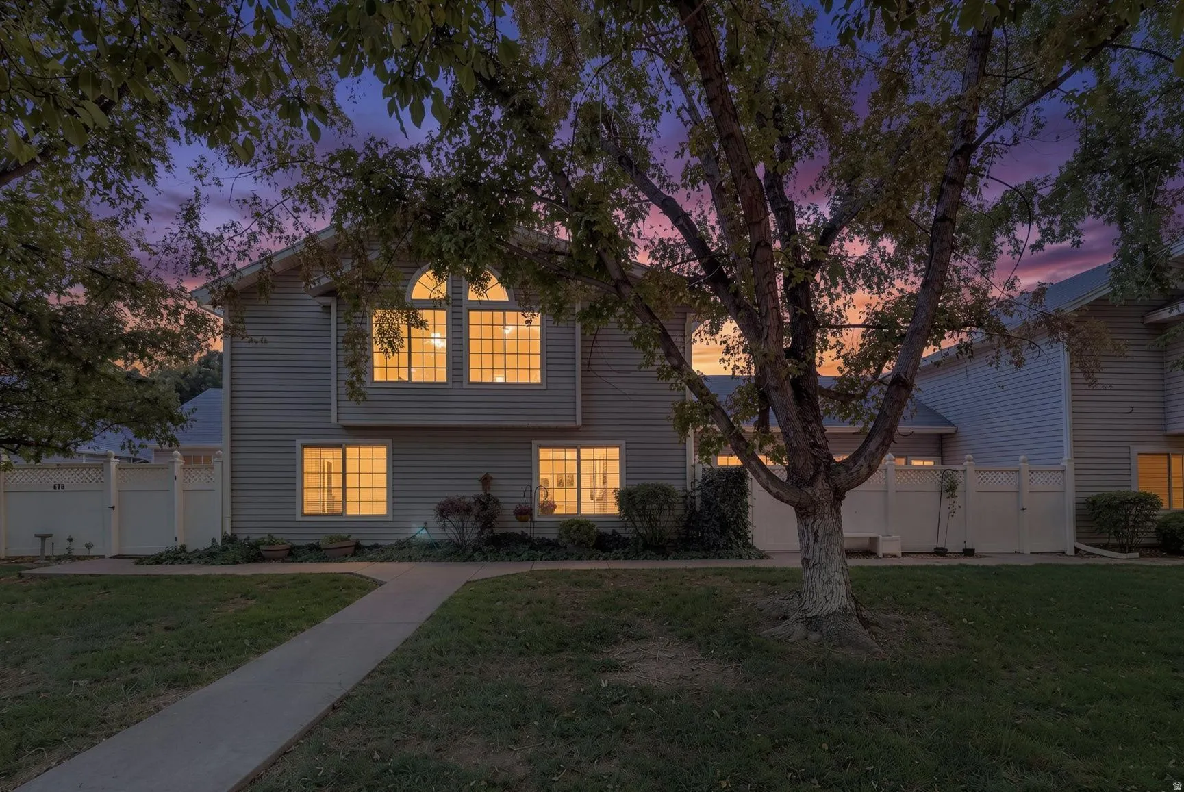 Siding exterior with multiple arched and rectangular windows, providing ample natural illumination
