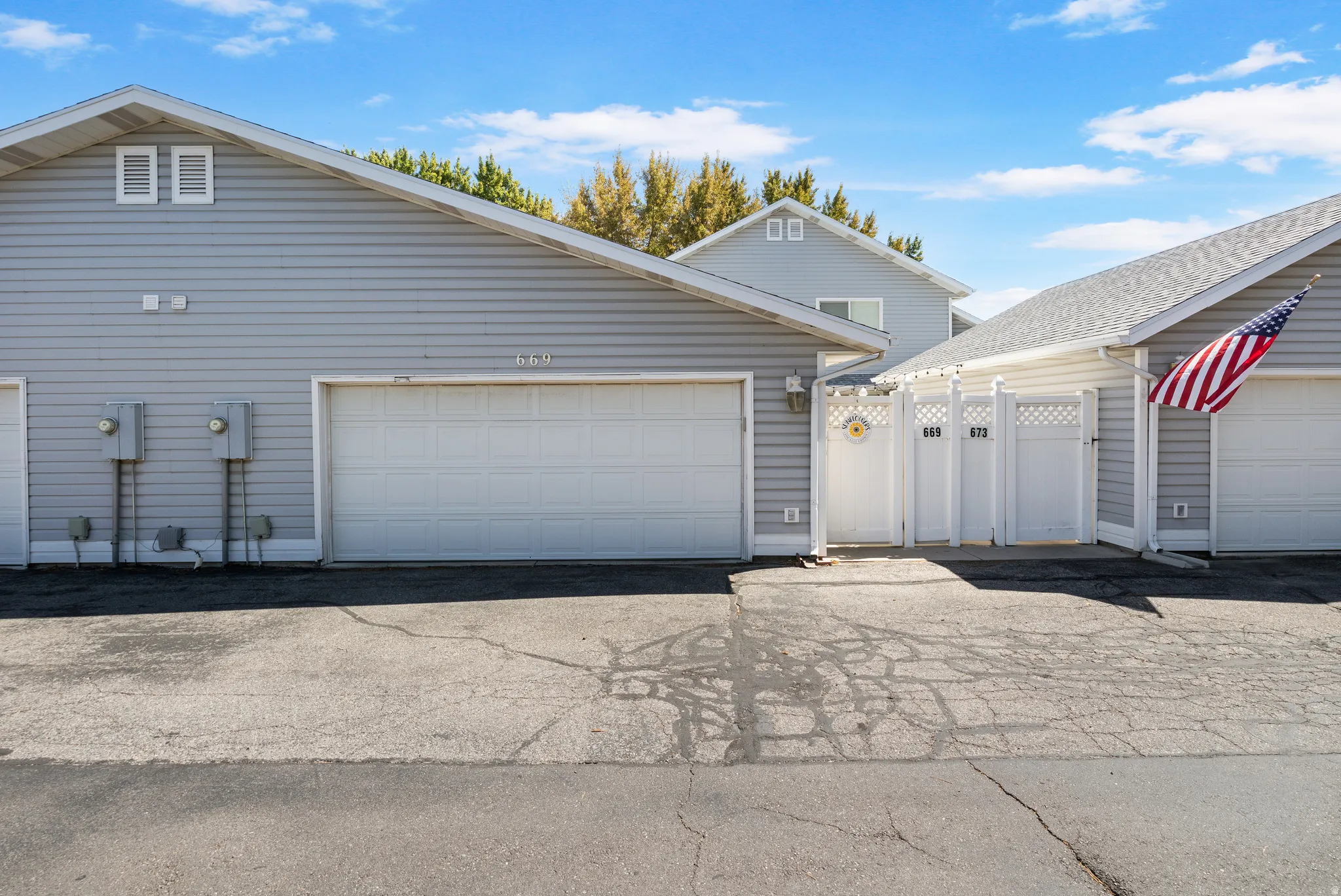 Siding exterior with a white garage door