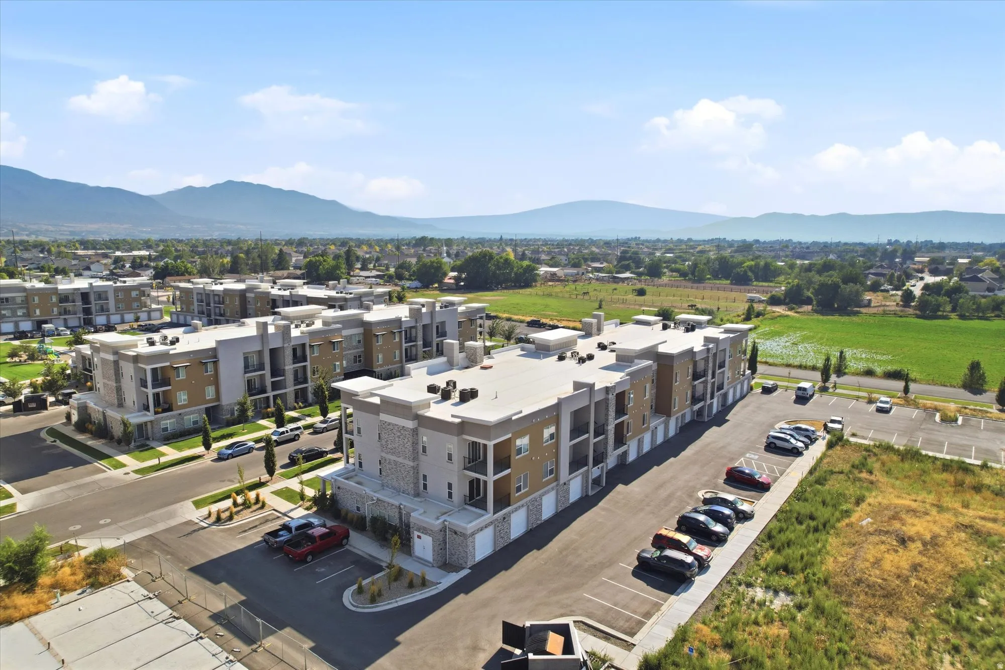 Modern multi-story buildings featuring stone, wood-tone, and stucco exteriors