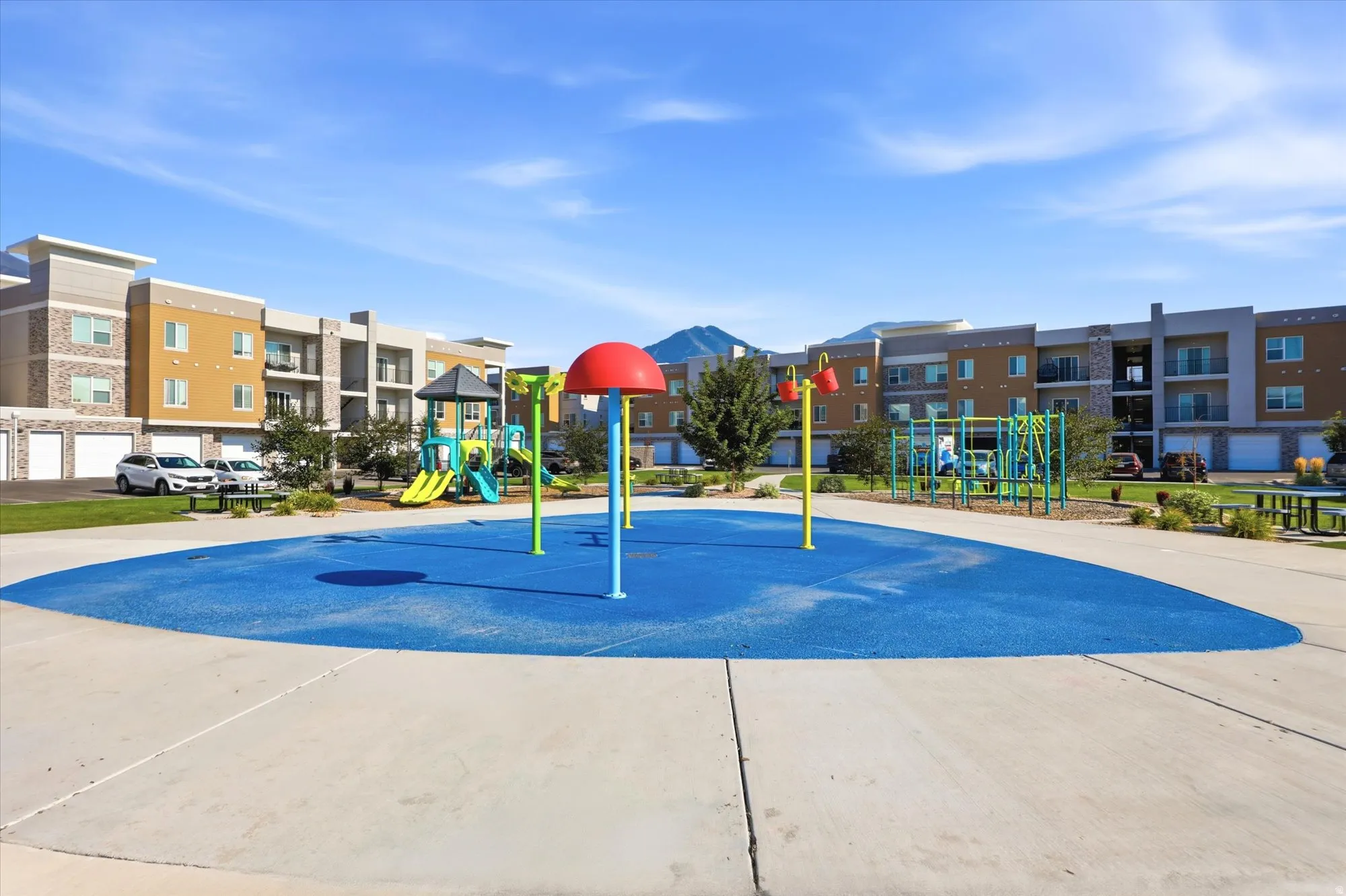 Outdoor splash pad area with a soft blue surface
