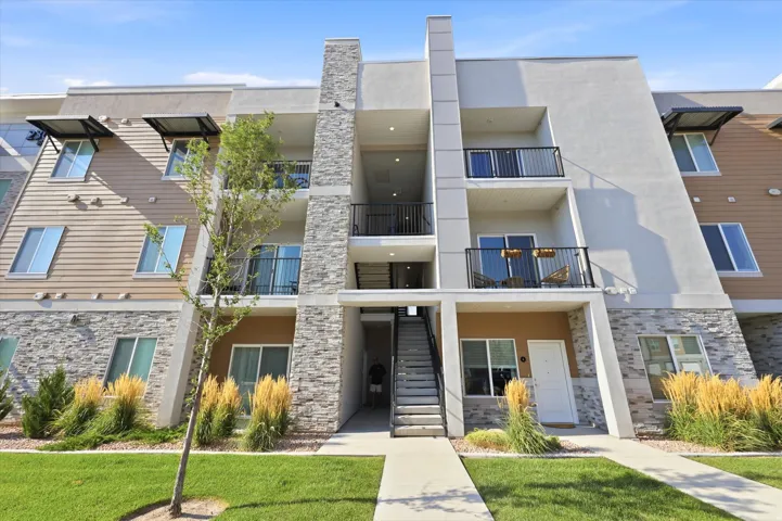 Contemporary multi-story building featuring stone veneer and horizontal siding accents