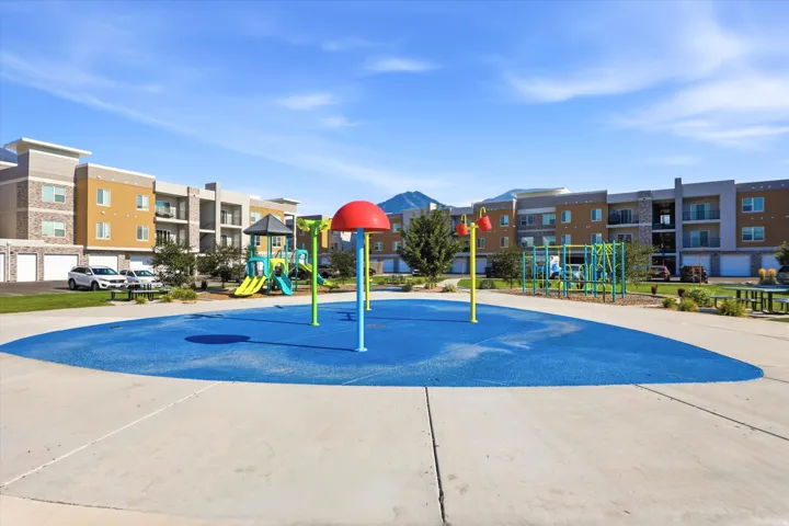 Outdoor splash pad area with a soft blue surface