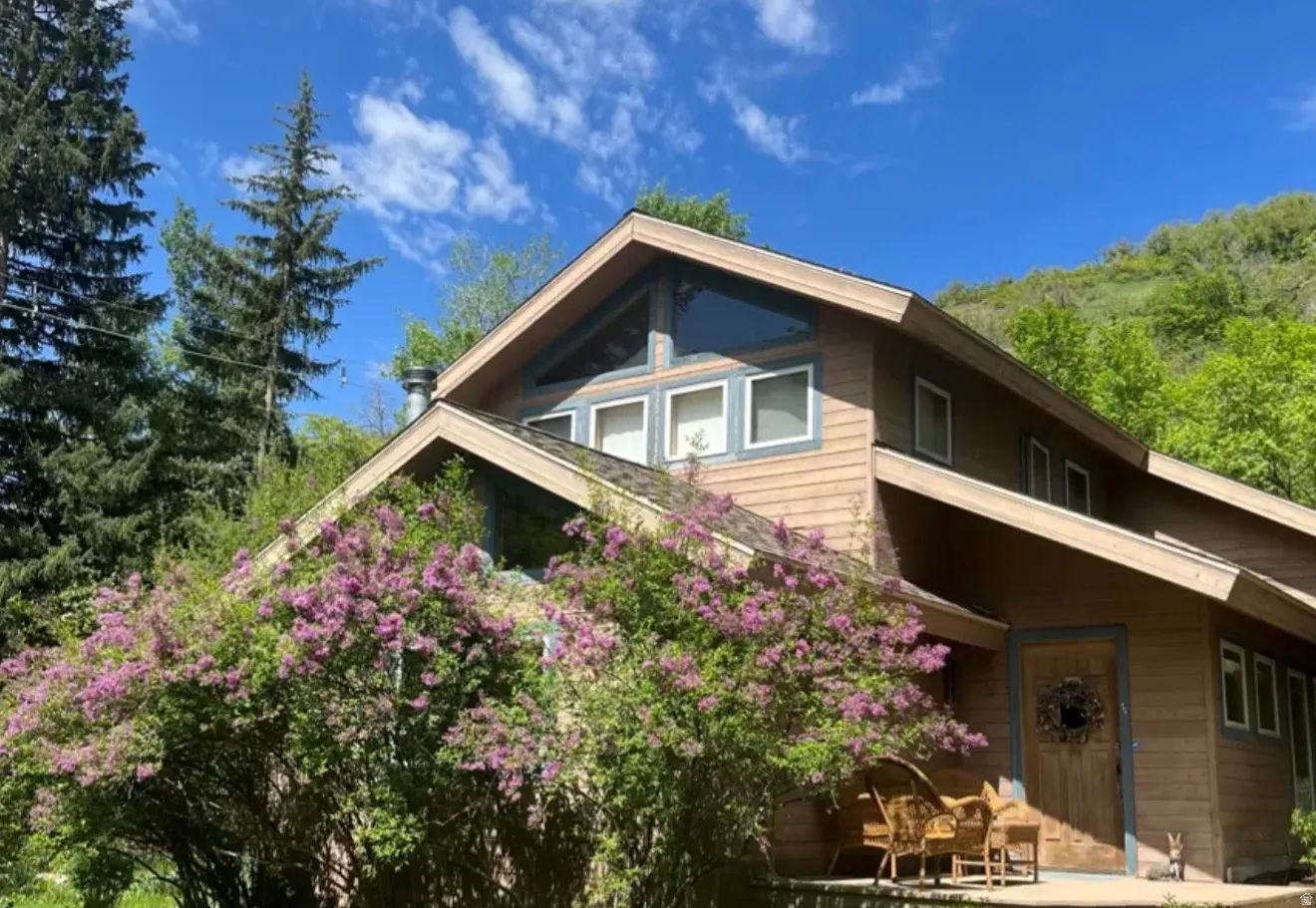 Wood siding exterior with a pitched roofline and prominent windows