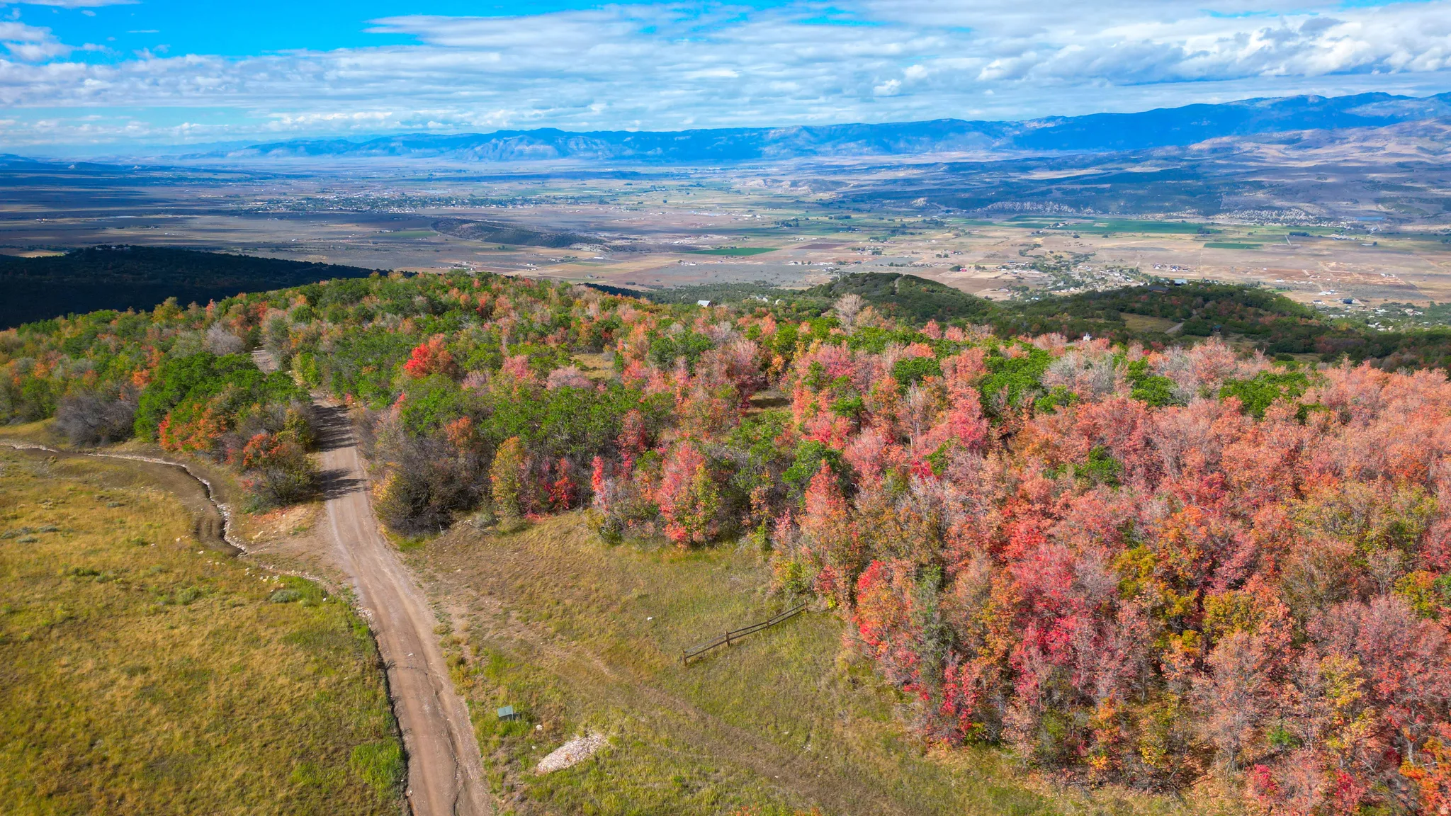 Expansive natural landscape with varied terrain and vibrant autumnal foliage