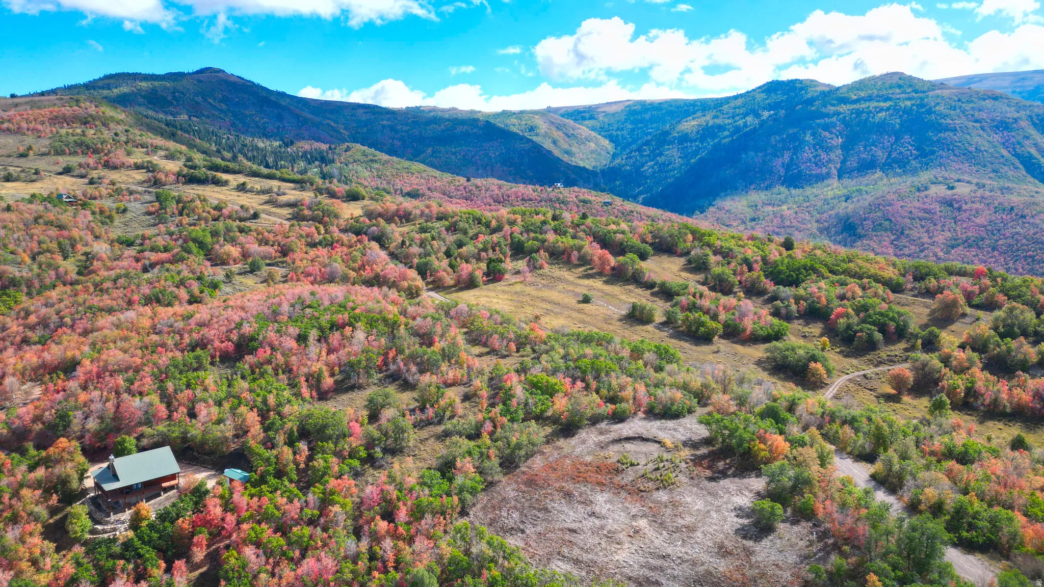 Expansive mountainous landscape featuring abundant trees and natural terrain