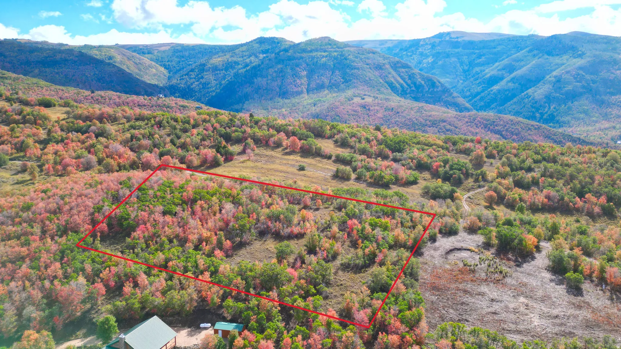 Expansive mountain landscape with varied terrain and vibrant foliage
