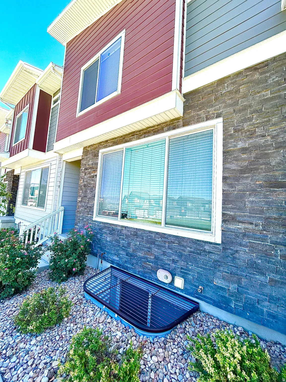 Modern exterior with multi-toned siding and stone accents