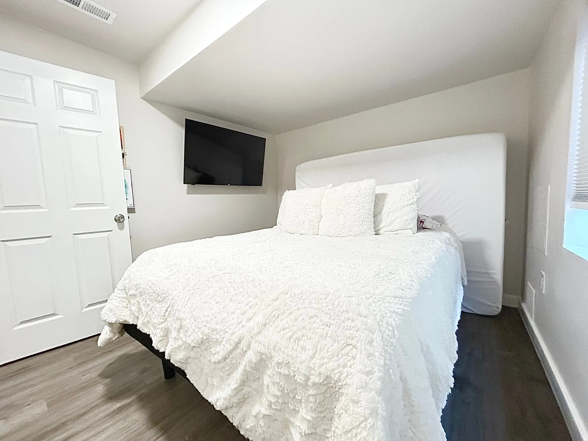 Recessed lighting, wood-finish flooring, and white paneled doors