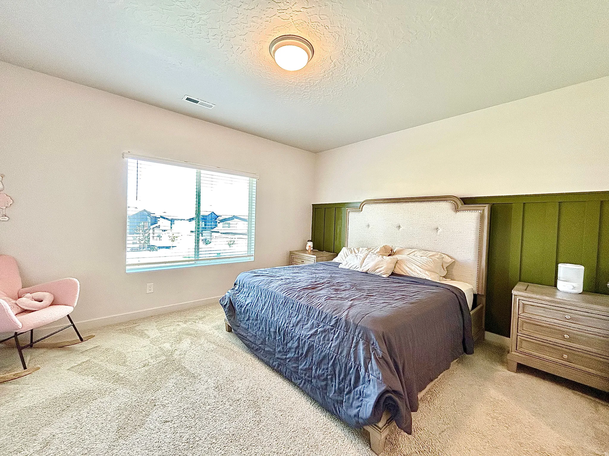 Recessed ceiling light fixture, wall-to-wall carpeting, window with blinds, and decorative wainscoting