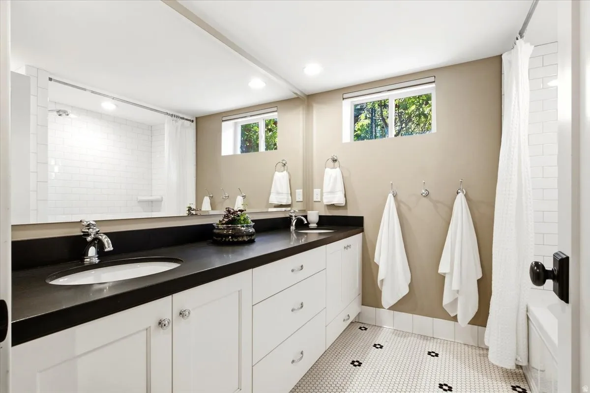 Double vanity with undermount sinks and dark countertops