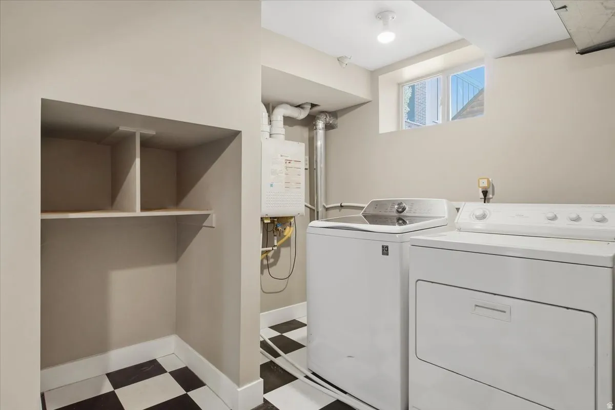 Laundry area with checkered tile flooring, built-in shelving, and a visible water heater
