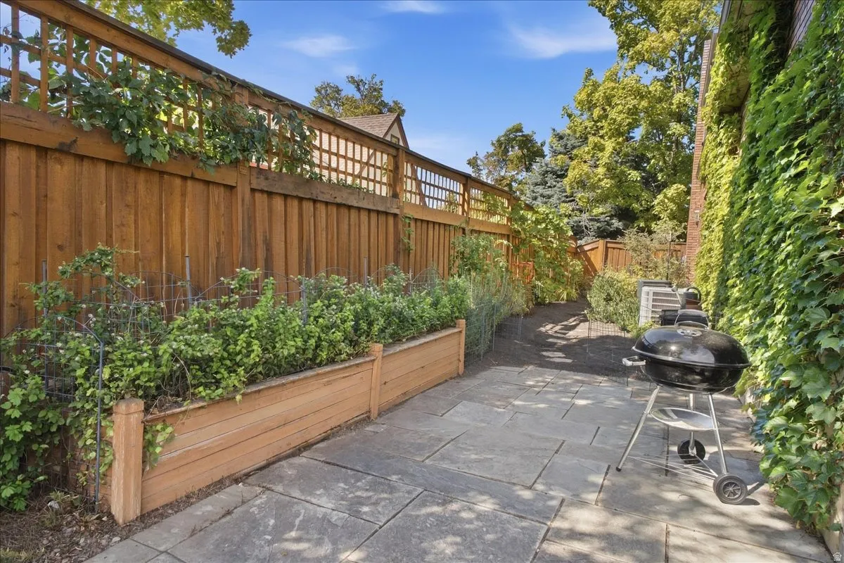 Stone-paver patio with a wood privacy fence and lattice detailing