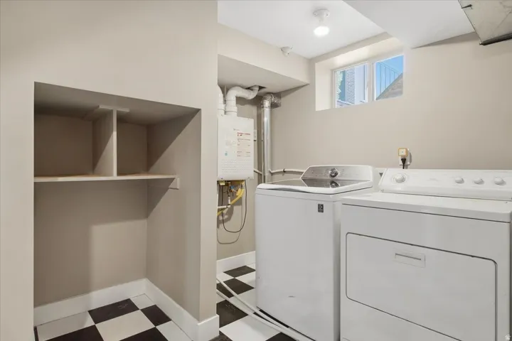 Laundry area with checkered tile flooring, built-in shelving, and a visible water heater