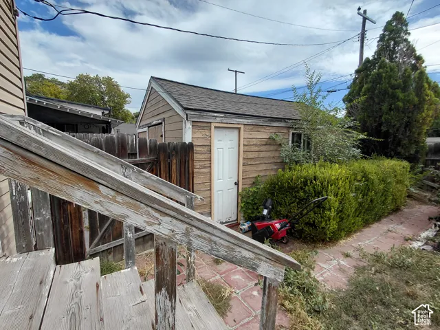 Wood-sided outbuilding with an asphalt shingle roof