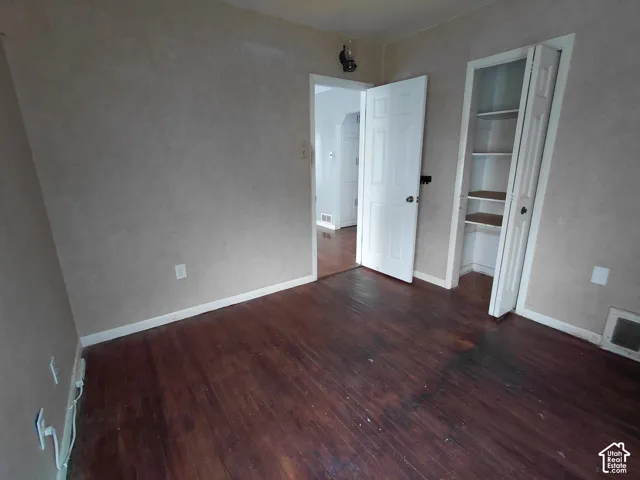 Dark wood-finish flooring with light-toned walls