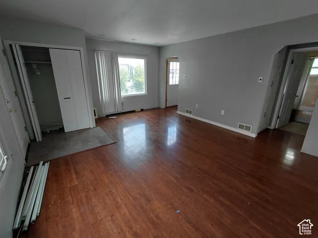 Wood-finish flooring throughout, light gray wall color, and white trim