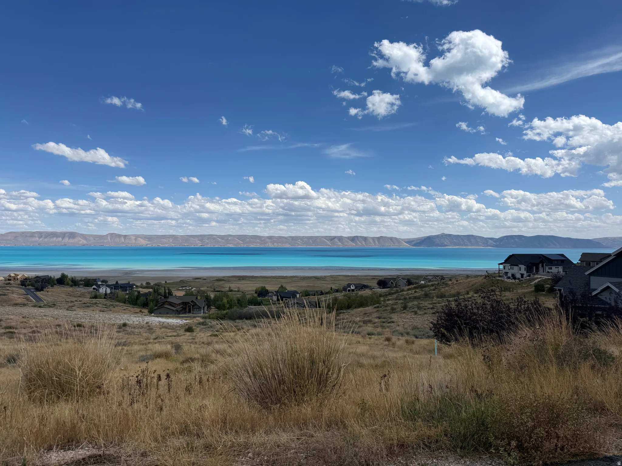 Expansive lake and mountain scenery from a hillside property