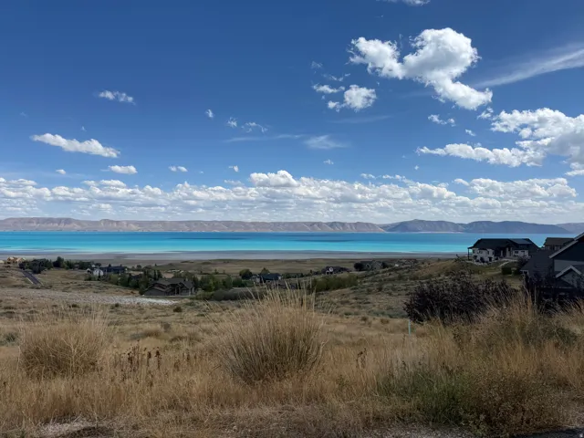 Expansive lake and mountain scenery from a hillside property