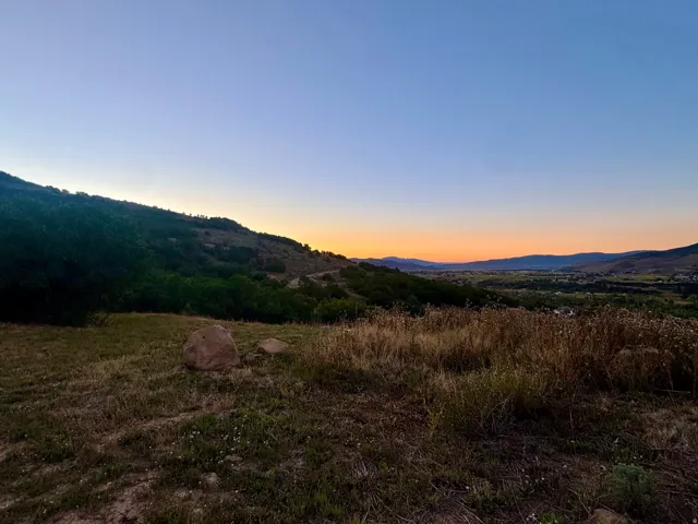 Expansive mountain landscape with natural vegetation and distant valley