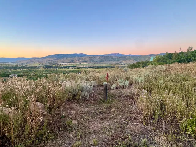 Expansive undeveloped land with distant mountain ranges and a valley landscape