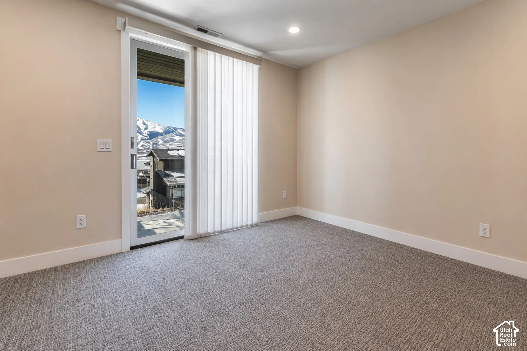 Neutral-toned walls complement textured carpeting