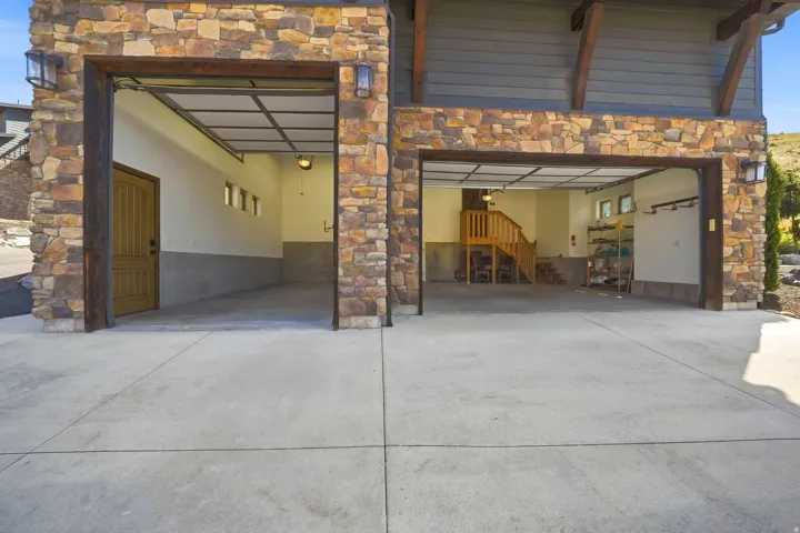 Stone veneer exterior with two integrated garage bays